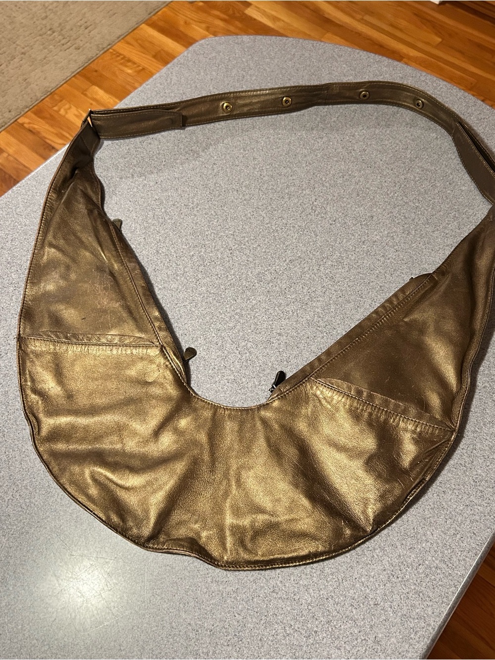 Sash Bag genuine leather gold crossbody bag with adjustable strap.